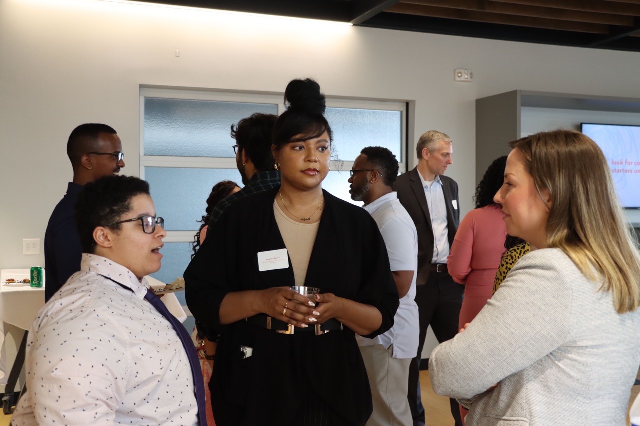 Kelly Slenk (right), Corewell Health Manager of Governance and Compliance, connects with Cybersecurity students Adrian Morgan-Jimmerson (left) and Angelica Pointer (center) at WMCAT’s Mix + Mingle networking event.