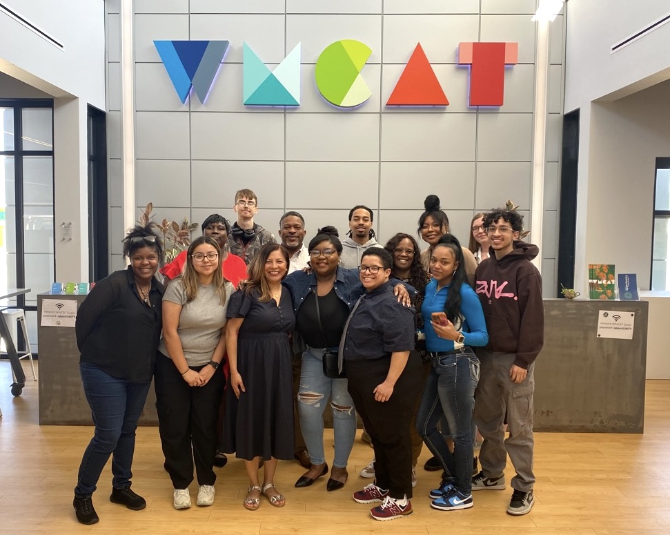 Stacia Mason (center) — 2023 WMCAT Cybersecurity graduate and current Acrisure employee — poses with GRC students after presenting to the group. 